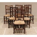 A matched set of twelve ash and elm rush seat spindle back chairs, 19th century, each with two