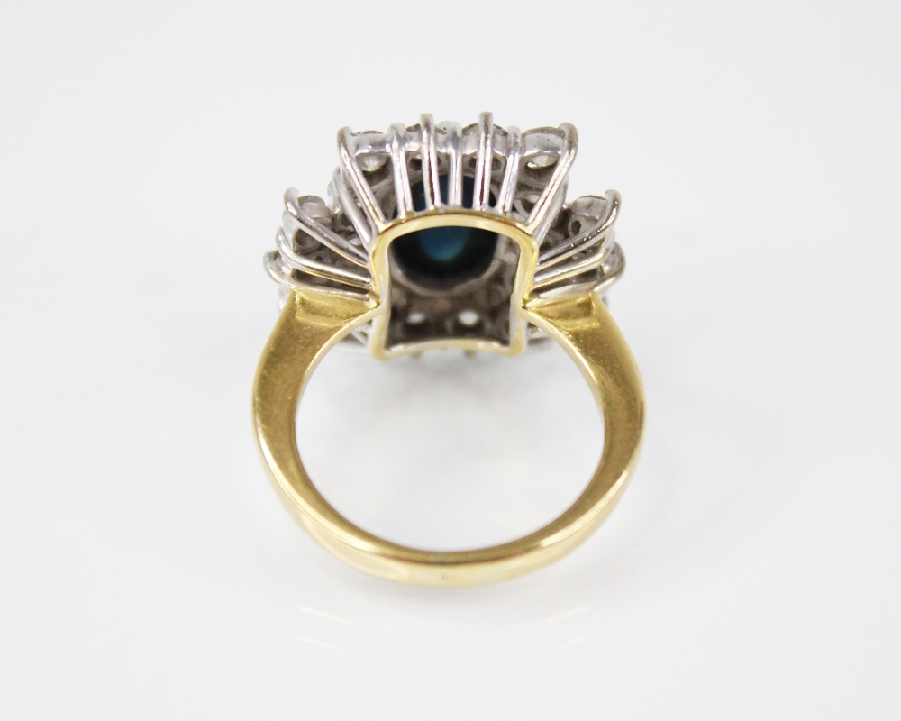 A sapphire and diamond cluster ring, the central oval sapphire cabochon measuring 11mm x 7.5mm, with - Image 4 of 4