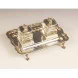 A George V silver desk stand, Elkington & Co, Birmingham 1934, the shaped rectangular base raised on