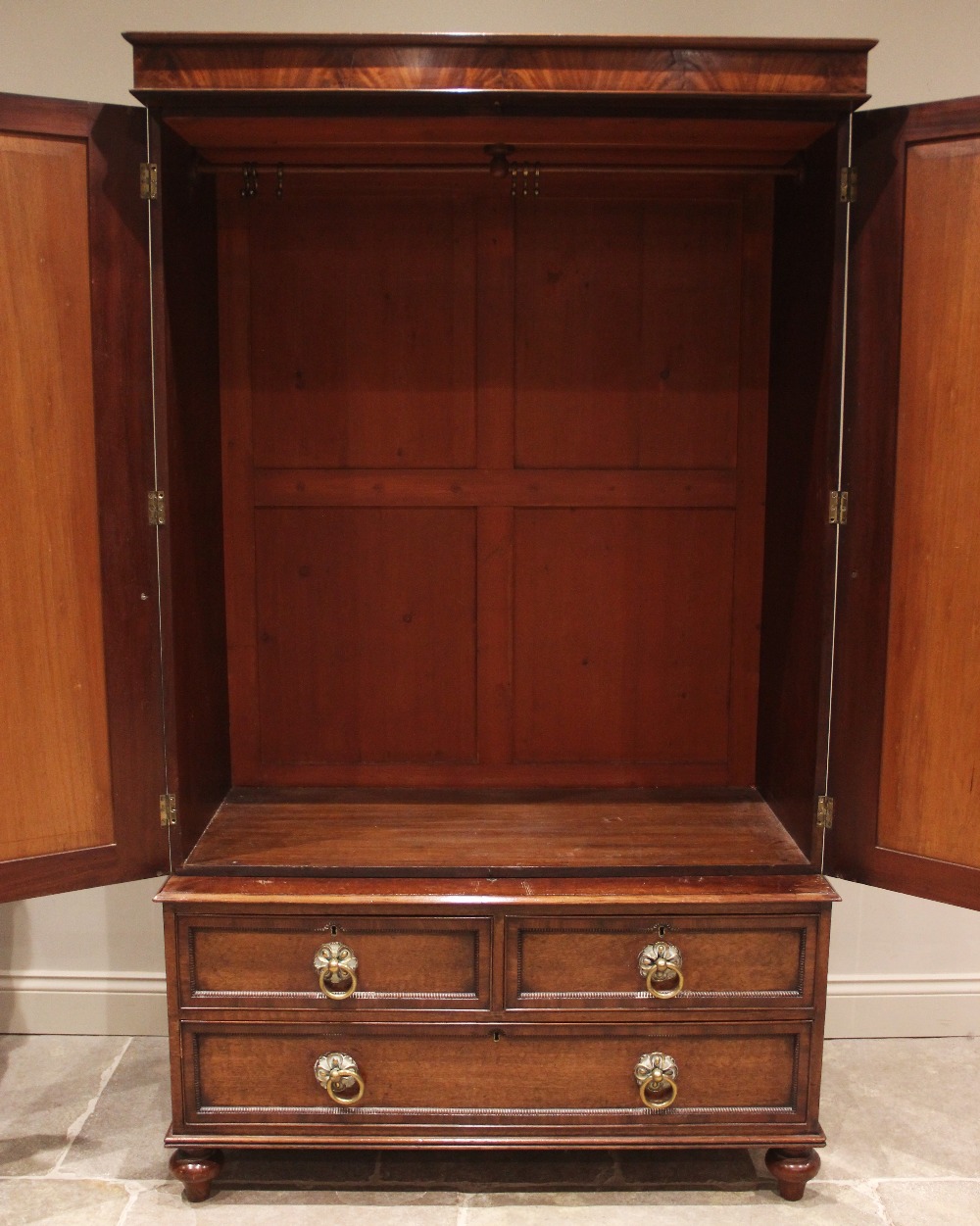 A William IV plum pudding mahogany wardrobe, the moulded cornice and plain frieze over a pair of - Image 2 of 2