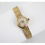 A ladies vintage Omega Automatic 9ct gold wristwatch, the circular dial with baton markers, set to a