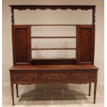 A George III oak and mahogany crossbanded dresser,