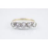 An early 20th century five stone diamond ring, the central round brilliant cut diamond