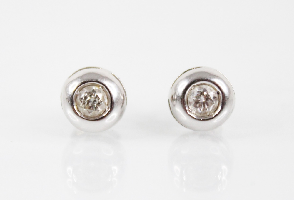 A pair of diamond solitaire earrings, each comprising a round brilliant cut diamond, each set in
