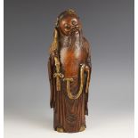 A Chinese carved bamboo figure of Zhongli Quan, gilt highlighted, modelled standing holding a fan,