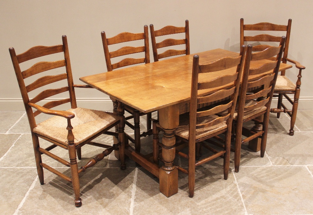 A 17th century style honey oak refectory table, 20th century, the rectangular top above a nulled