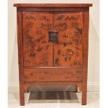 A red lacquer Chinese wedding cabinet, 20th century, probably elm, the twin doors adorned with