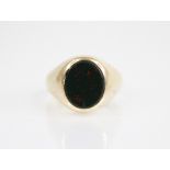 A bloodstone set signet ring, the central oval bloodstone panel measuring 12.3mm x 10.3mm,