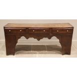 An elm and oak dresser base/work bench, 18th century and later, the plank top over three frieze