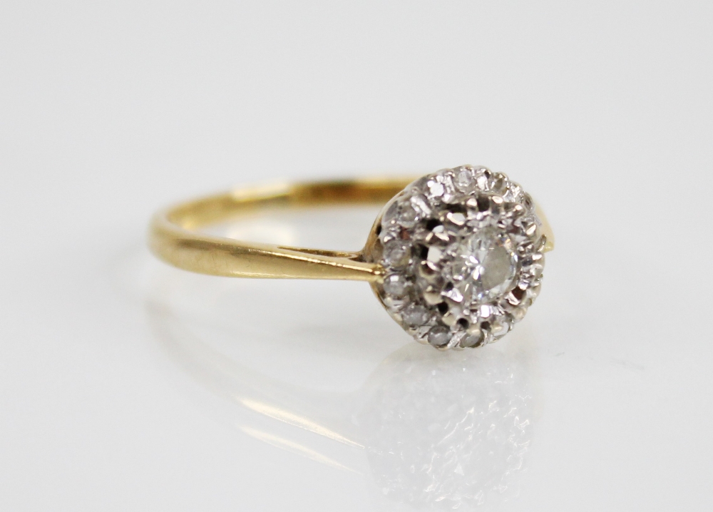 A diamond cluster 18ct gold ring, the central round brilliant cut diamond weighing approximately 0. - Image 2 of 5