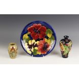 A Moorcroft plate in the Hibiscus pattern against a cobalt blue ground, mid to late 20th century,