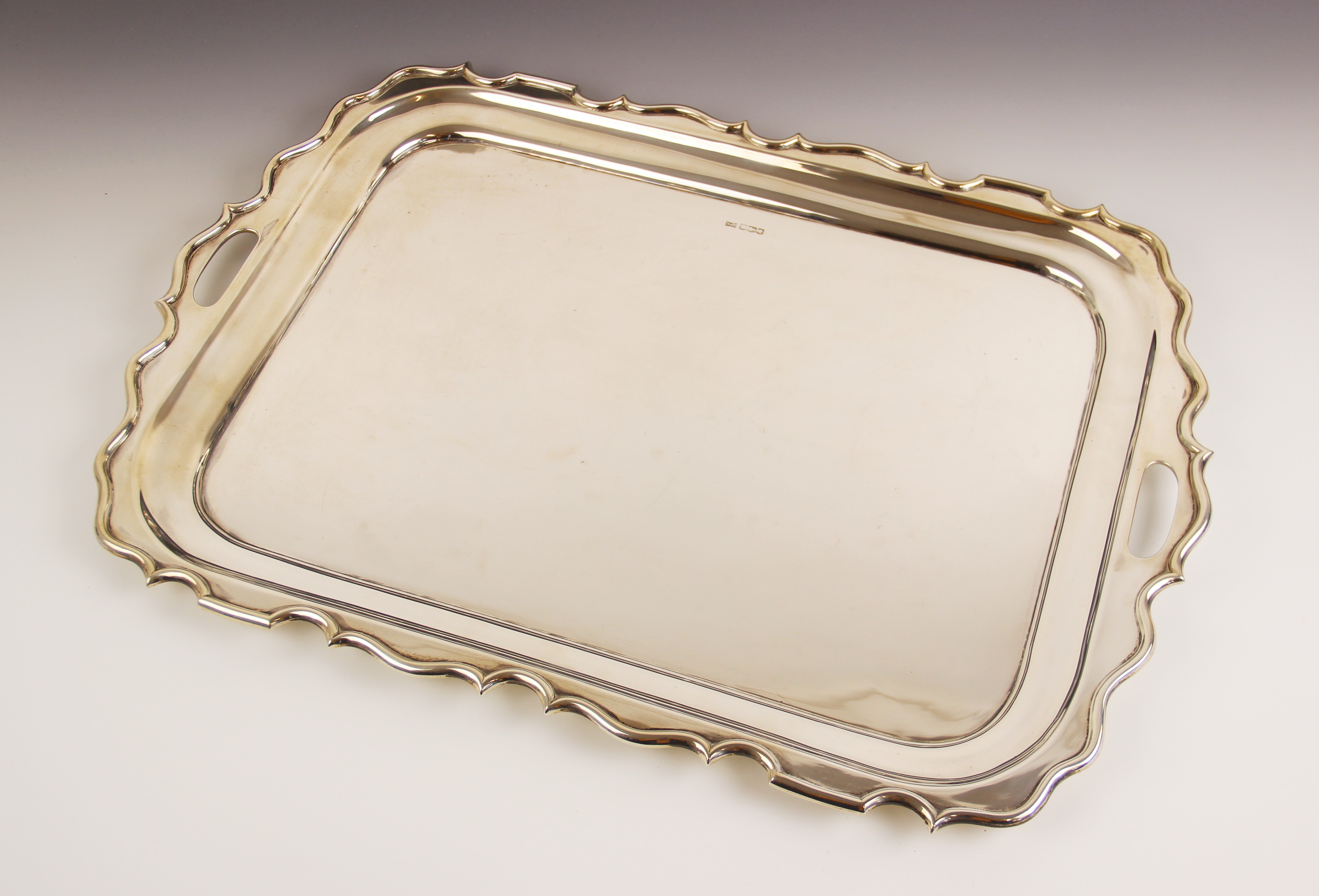 A George V twin-handled silver tray, Walker & Hall, Sheffield 1921, of rectangular form with ogee