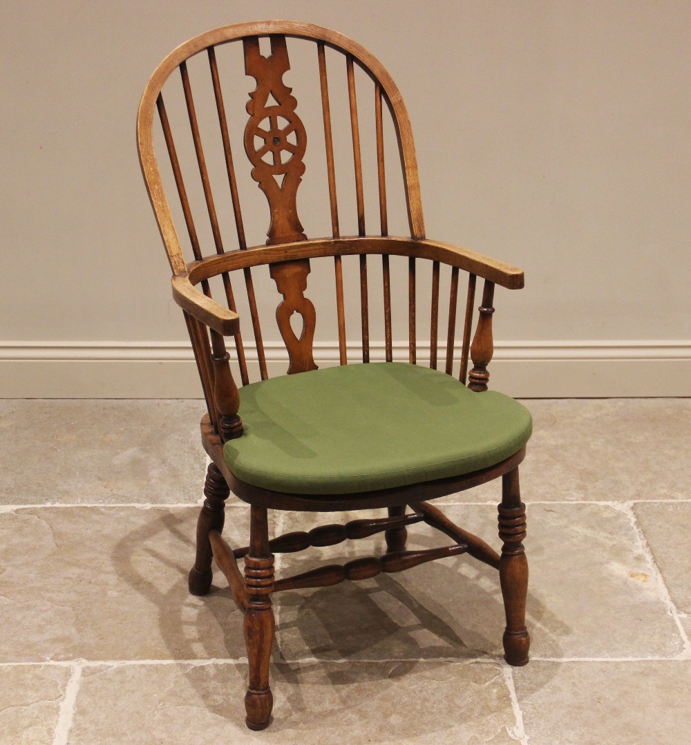 A 19th century style ash and beech wheel back Windsor elbow chair, 20th century, with a hoop back