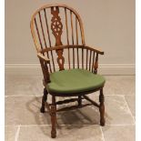 A 19th century style ash and beech wheel back Windsor elbow chair, 20th century, with a hoop back