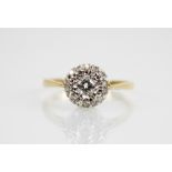A diamond cluster 18ct gold ring, the central round brilliant cut diamond weighing approximately 0.
