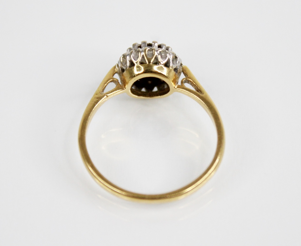 A diamond cluster 18ct gold ring, the central round brilliant cut diamond weighing approximately 0. - Image 4 of 5