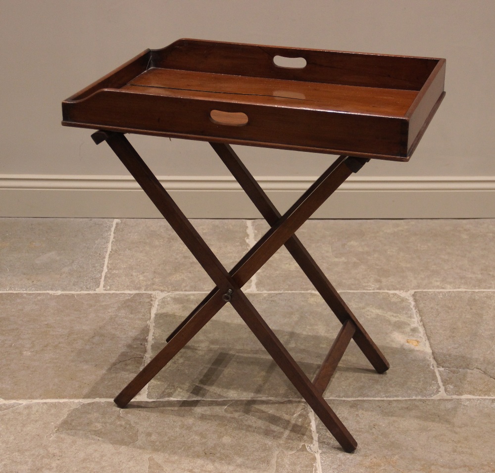 A mahogany butlers tray and associated stand, 19th century, the galleried tray with hand apertures