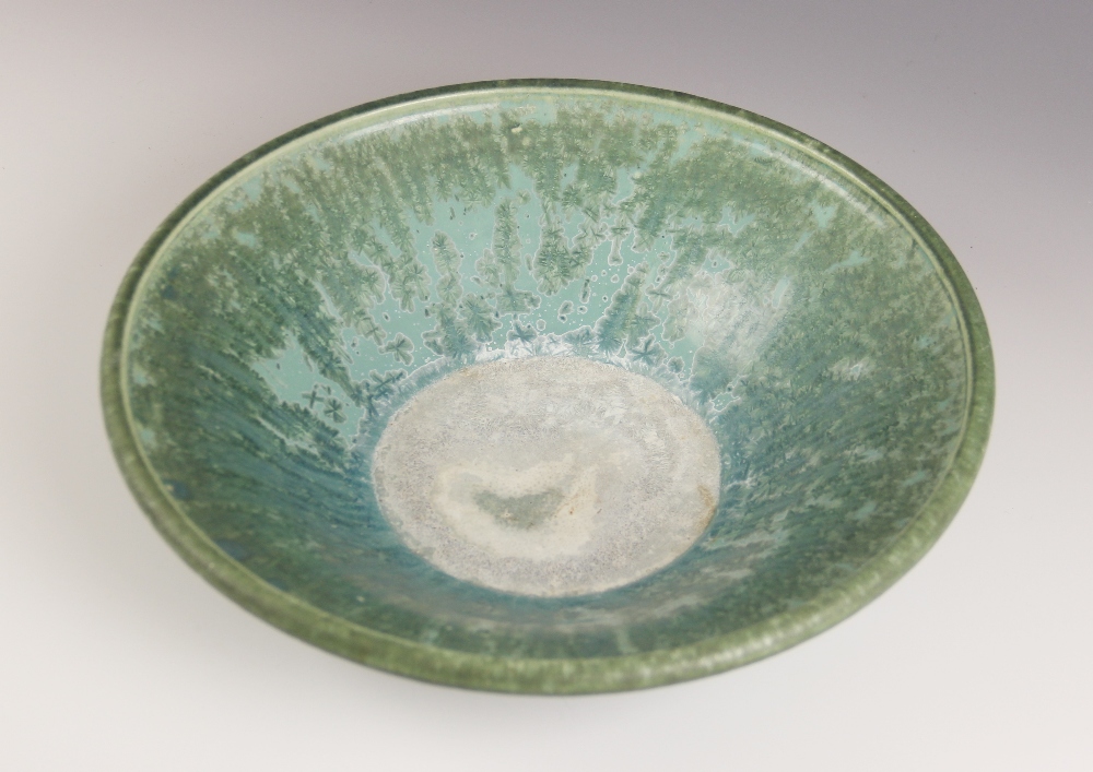 A studio pottery bowl, 20th century, of shallow flared form with rolled rim, the celadon green