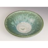 A studio pottery bowl, 20th century, of shallow flared form with rolled rim, the celadon green