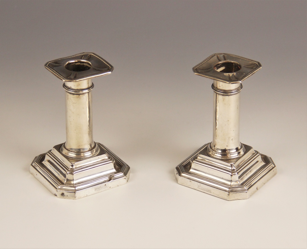 A pair of Edwardian silver mounted candlesticks, James Dixon & Sons Ltd, Sheffield 1905, the plain