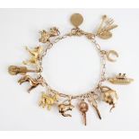 A gold coloured charm bracelet, the cable link bracelet with spring ring and loop fastening