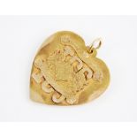A 14ct gold heart-shaped pendant, with applied crest for the 'Womens Auxiliary' of The International