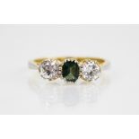 A diamond and garnet topped doublet ring, the central green coloured mixed cut garnet topped doublet