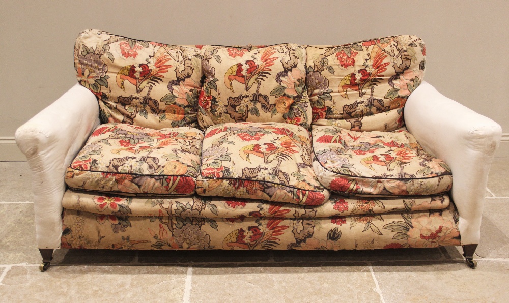 A late Victorian sofa in the manner of Howard & Sons, partially covered in William Morris type