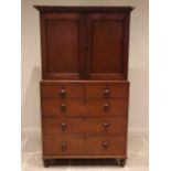 A walnut linen press, 19th century, the cavetto cornice over a pair of panelled doors opening to