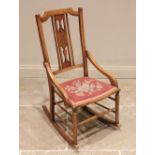 A Secessionist/Art Nouveau beech rocking chair, by Ray & Miles, Liverpool, early 20th century, the