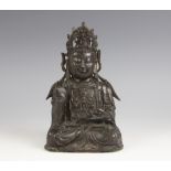 A Sino-Tibetan bronze figure of buddha, seated in dhyanasana, right hand in vitarka mudra, left hand