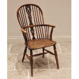 A 19th century yew and elm Windsor elbow chair, the hoop back with central pierced splat above the