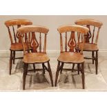 A set of four Victorian elm and beech kitchen chairs, each with a pierced and inverted vase shaped