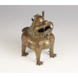 A Chinese bronze 'Luduan' incense burner, modelled standing on four legs with hinged head forming