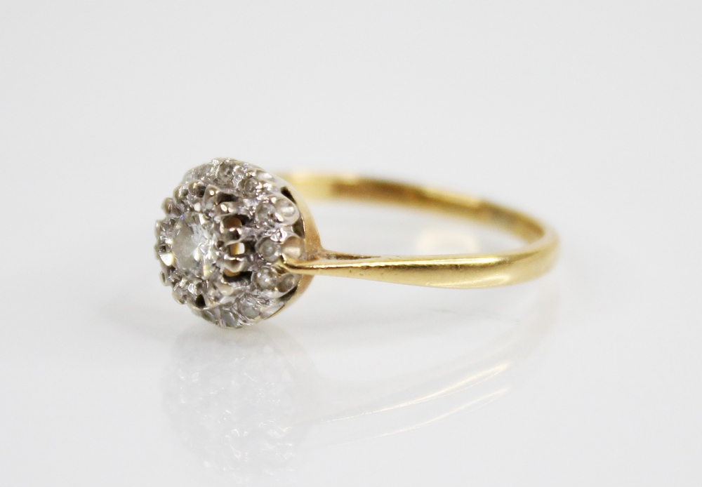 A diamond cluster 18ct gold ring, the central round brilliant cut diamond weighing approximately 0. - Image 3 of 5