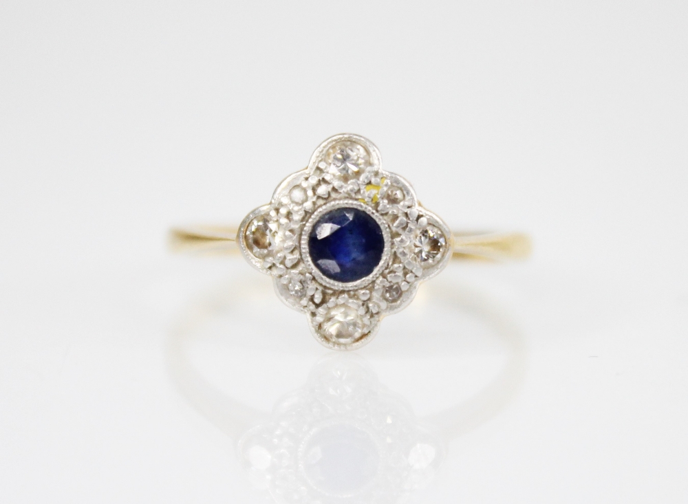 An early 20th century sapphire and diamond transitional ring, the central round mixed cut sapphire