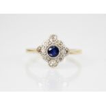 An early 20th century sapphire and diamond transitional ring, the central round mixed cut sapphire