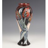 A Moorcroft vase in the Red Tulip pattern designed by Sally Tuffin, of slender inverted baluster