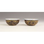 A pair of Chinese porcelain powder blue tea bowls, Qianlong mark, each circular shaped shallow