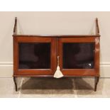 A glazed mahogany hanging wall cabinet, early 20th century, the curved brackets united by a pair