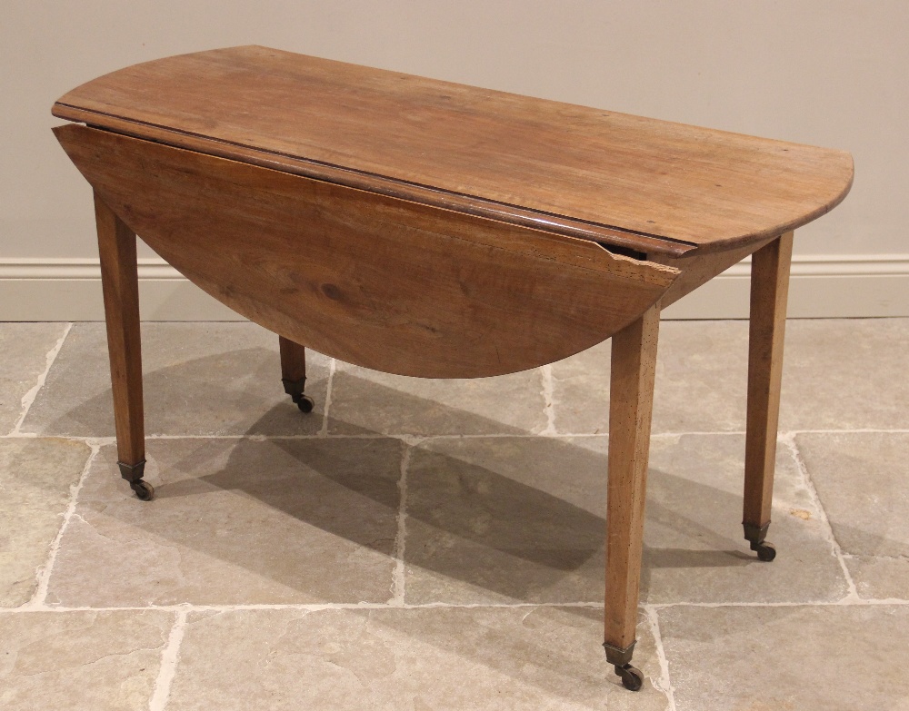 A cherry wood Pembroke table, mid 19th century, possibly French, the oval drop-leaf top upon legs of