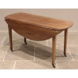 A cherry wood Pembroke table, mid 19th century, possibly French, the oval drop-leaf top upon legs of