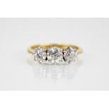 A diamond three stone ring, the central round old cut diamond weighing approximately 0.50 carats (