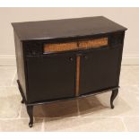 A continental ebonised music cabinet, mid to late 20th century, the moulded bowfront top over a