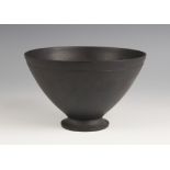 A Wedgwood black basalt bowl by Keith Murray, circa 1933, of conical form with incised border and