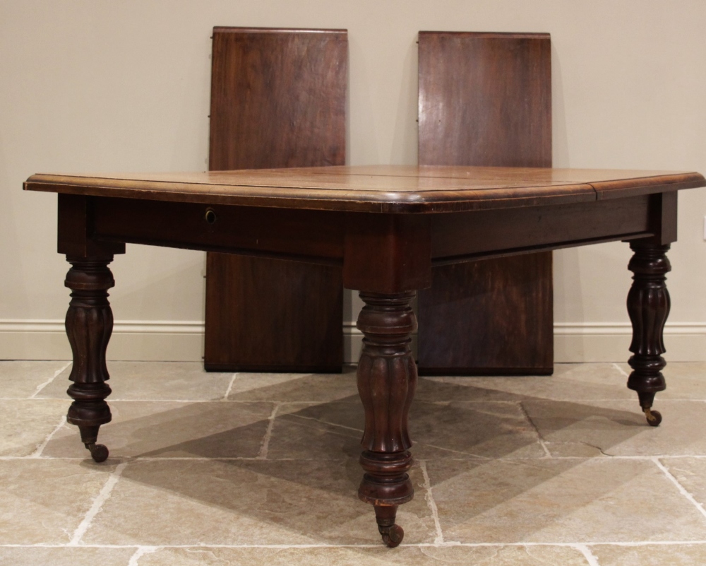 A Victorian mahogany extending dining table, the rectangular moulded top with rounded corners,