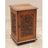 A carved oak side cabinet, late 19th/early 20th century, the rectangular moulded top over a single