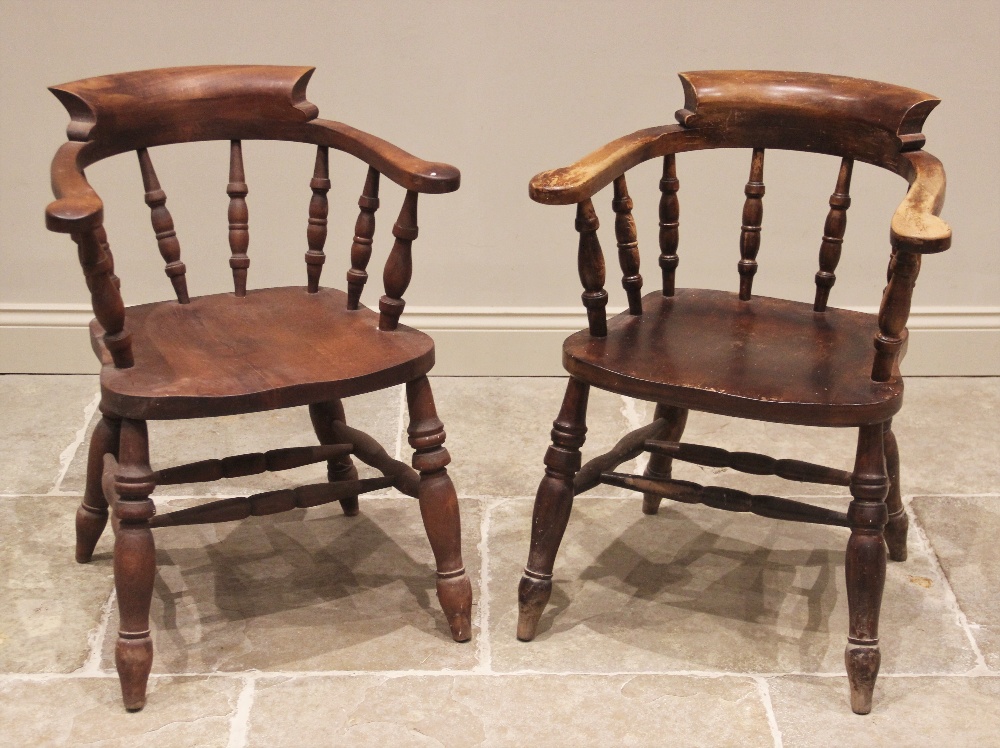 A Victorian style stained beech wood captains chair, 20th century, the horseshoe shaped top rail