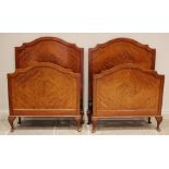A pair of mahogany single beds, in the manner of Maple & Co, early 20th century, the quarter