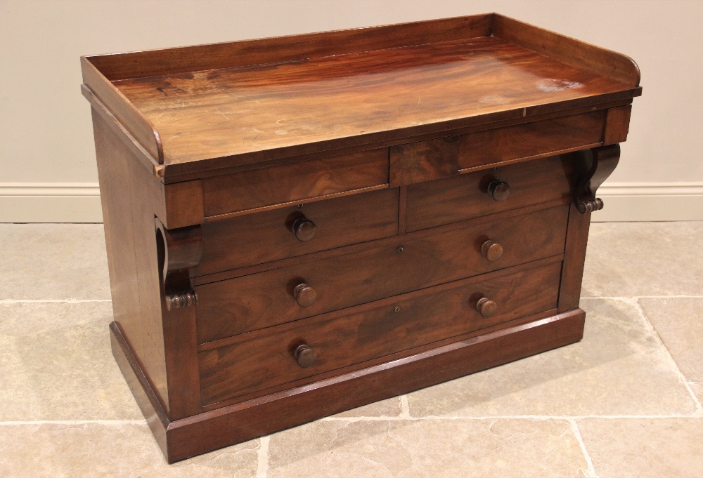 A mid 19th century mahogany tray top chest, the rectangular top with a three quarter gallery over